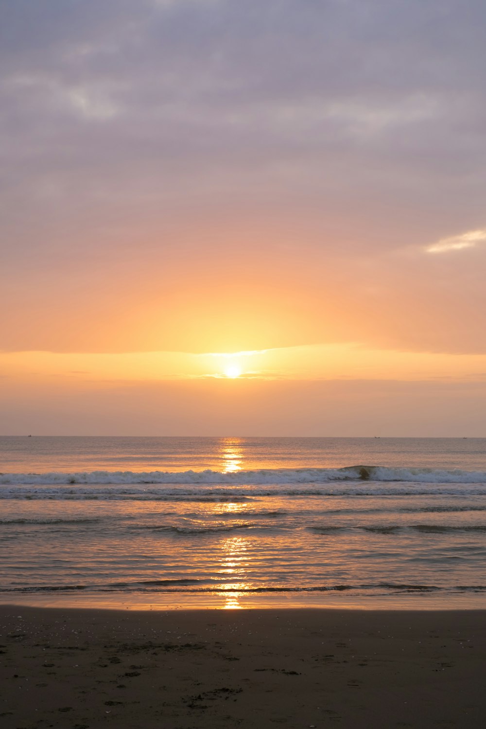 太陽がビーチの海に沈んでいる