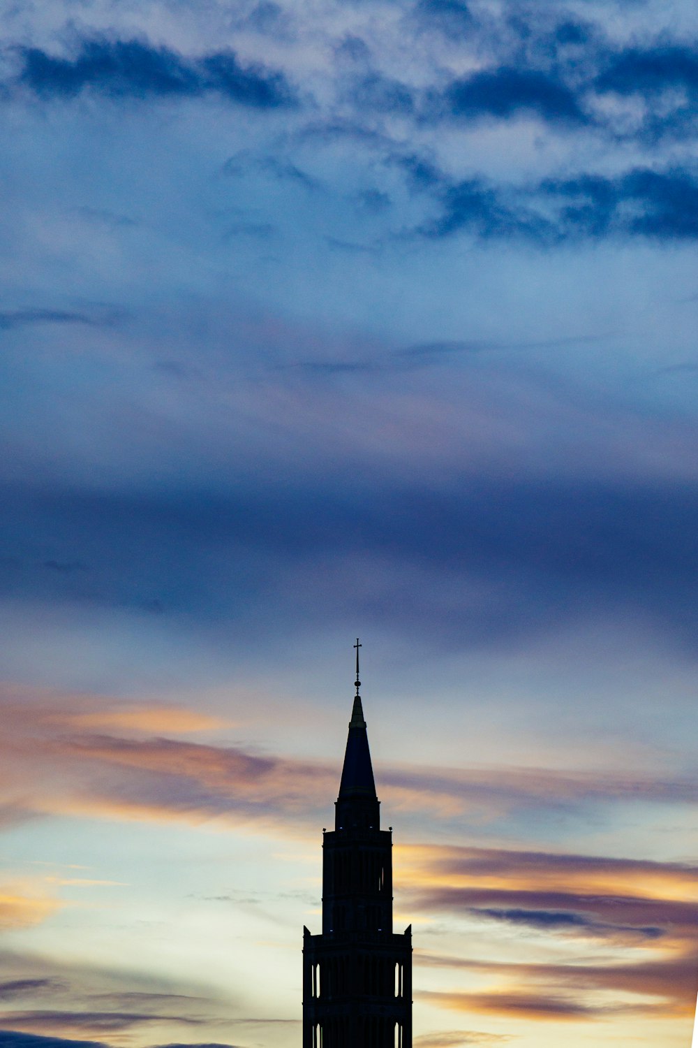 a tall clock tower sitting under a cloudy sky