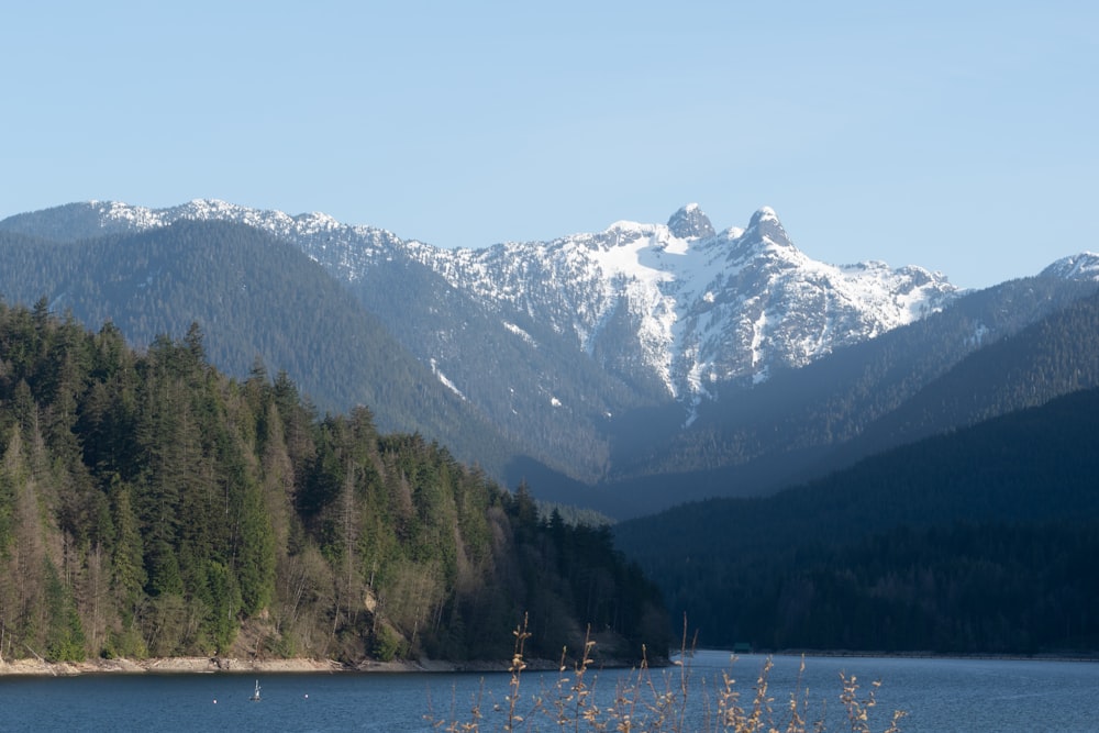 a view of a mountain range with a lake in the foreground