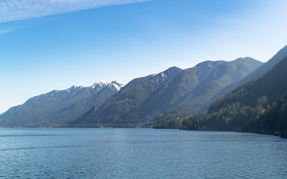 a body of water with mountains in the background