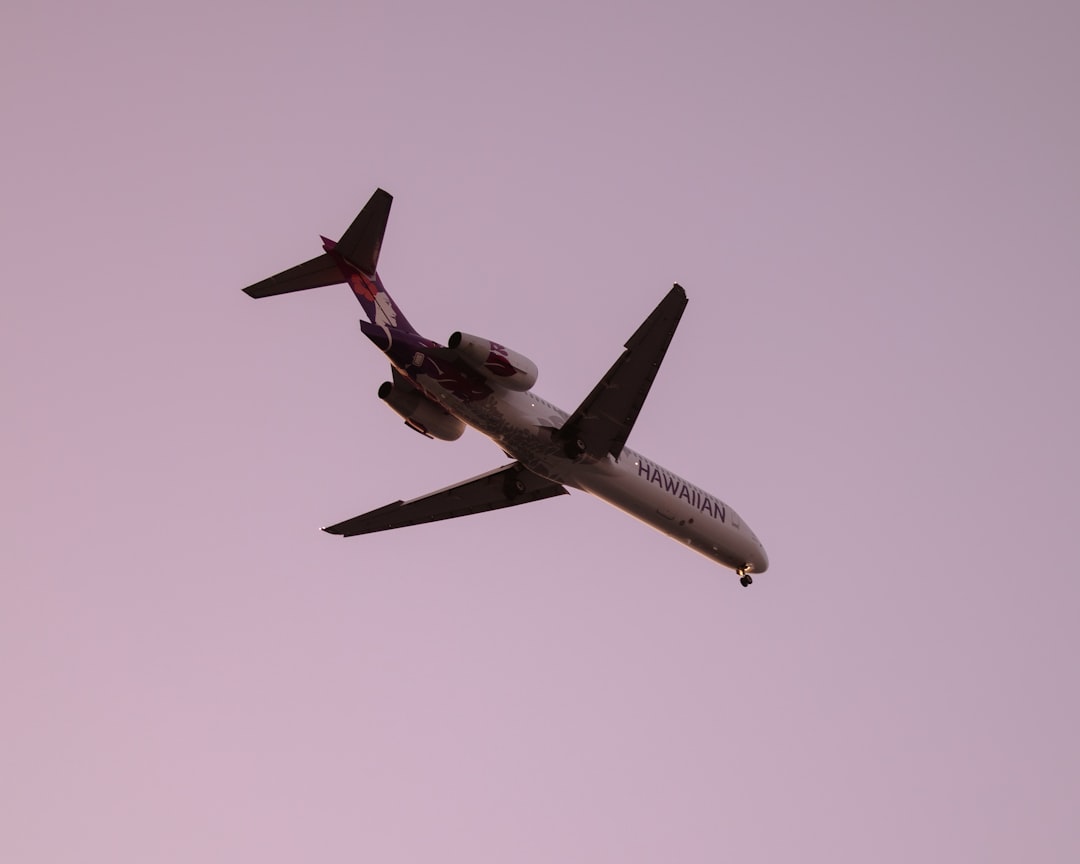 an airplane is flying in the sky on a clear day,