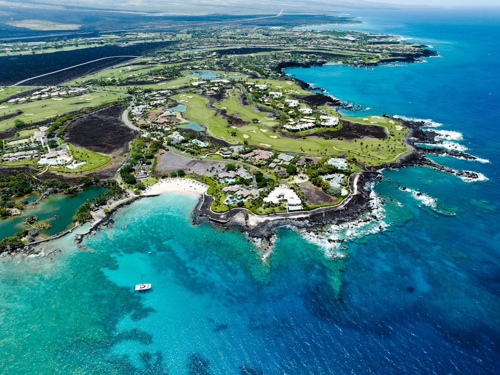 an aerial view of a golf course in the ocean