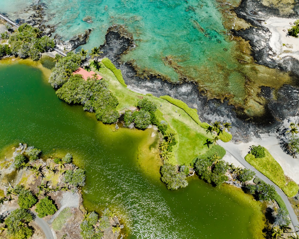 an aerial view of a body of water surrounded by trees