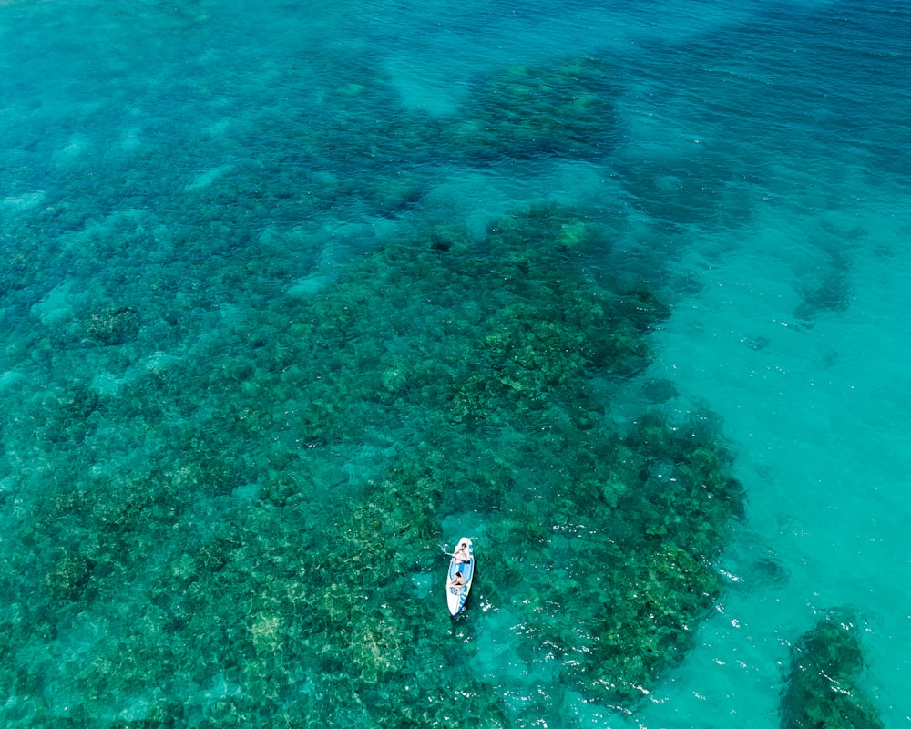 an aerial view of a boat in the ocean