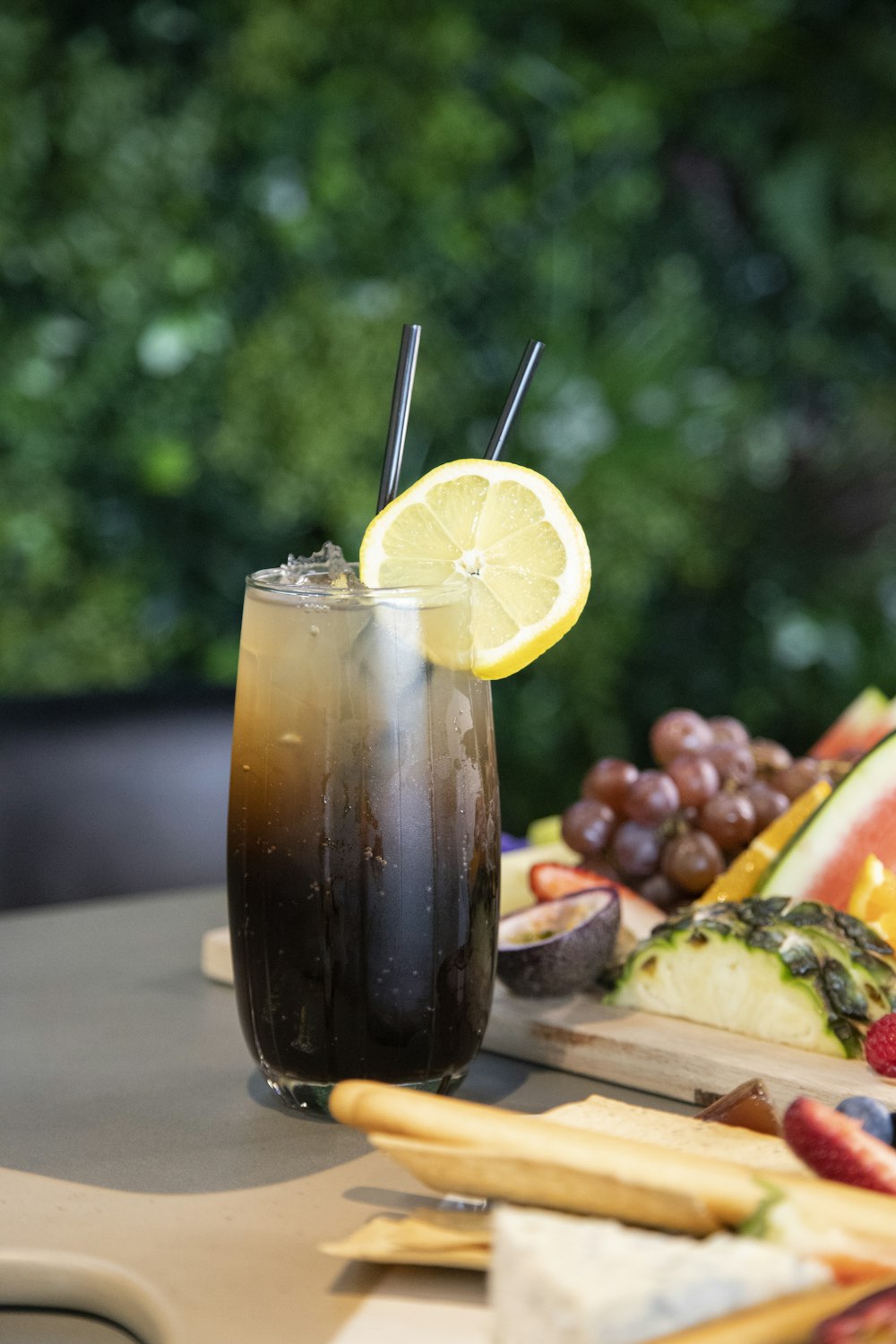 a drink with a slice of lemon on a cutting board