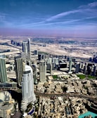 An aerial shot of Dubai’s business district blending into a table of fine desserts.