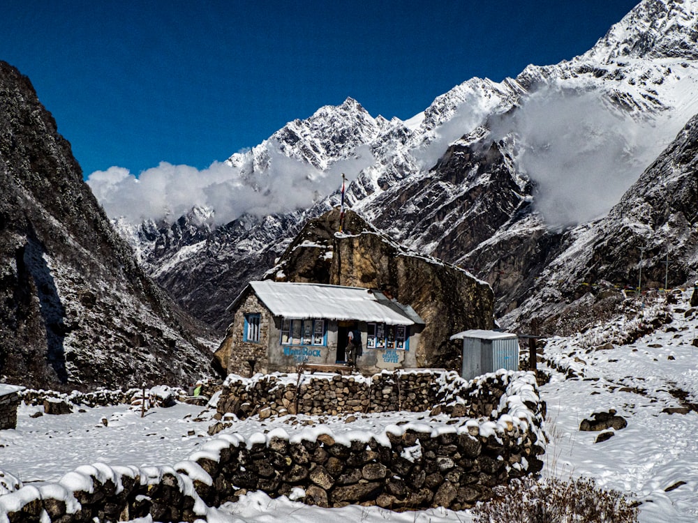 a house in the middle of a snowy mountain range