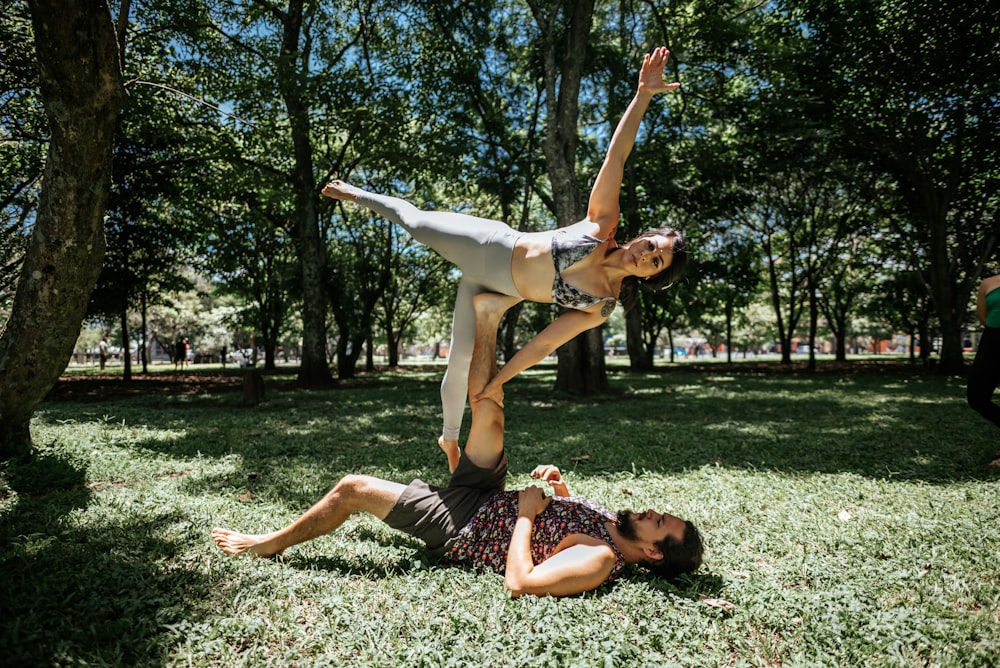 a couple of people that are in the grass