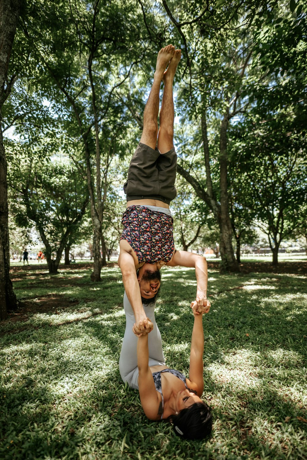 a man doing a handstand in a park