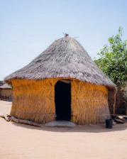 a straw hut with a thatched roof