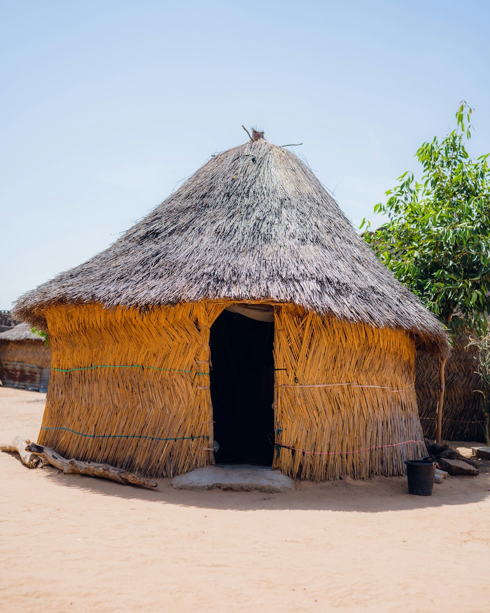 a straw hut with a thatched roof