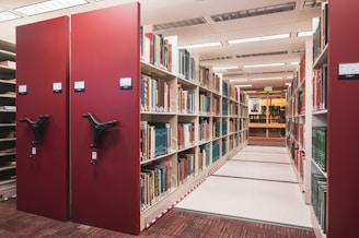 a row of bookshelves in a library filled with books