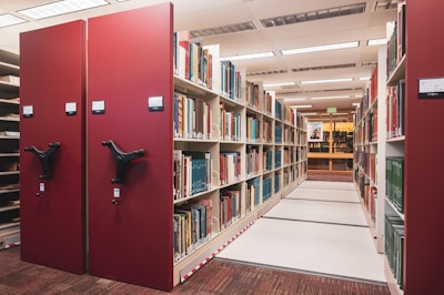 a row of bookshelves in a library filled with books
