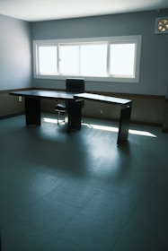 Legal documents and a gavel on a minimalist desk with natural light.