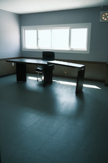 Minimalist office interior with natural light and a neat desk setup.