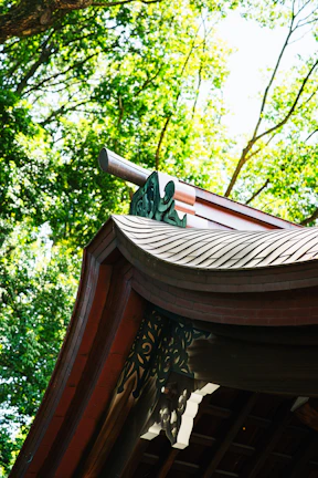 Close-up of intricate wooden carvings on a traditional joglo roof structure