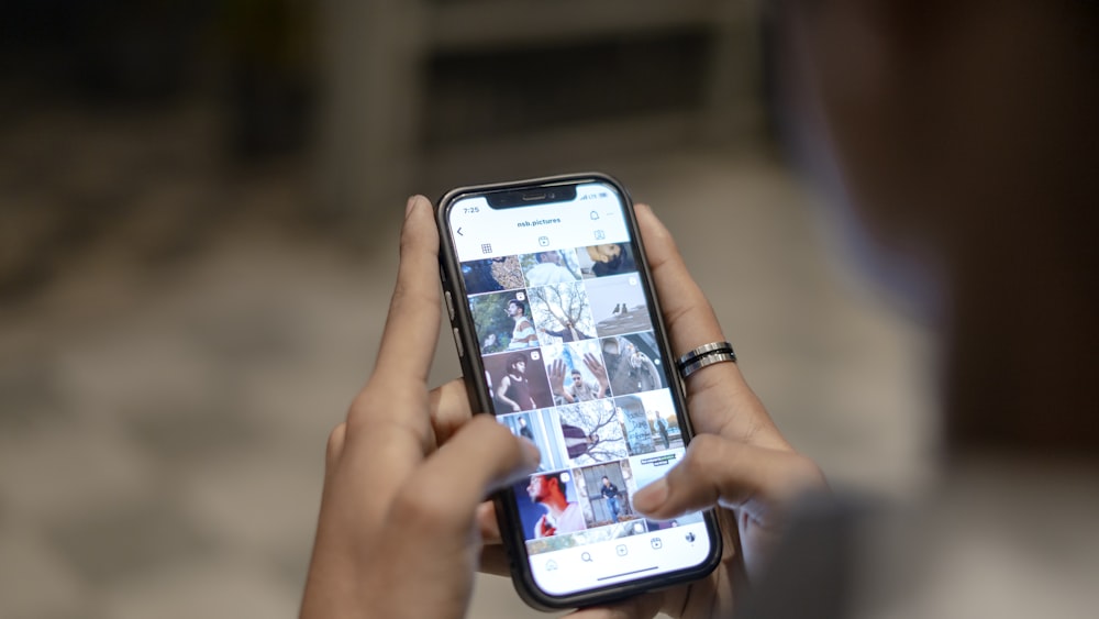 a person holding a cell phone in their hand