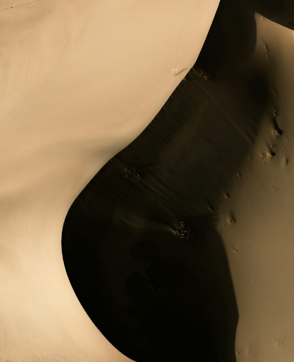 a black and white photo of a sand dune