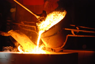 a large metal pot on fire in a dark room