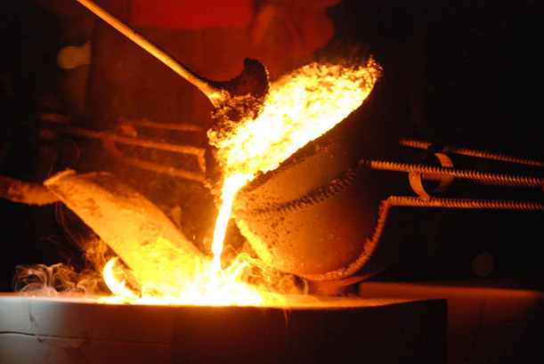 a large metal pot on fire in a dark room