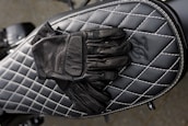 A rider wearing sl gloves on a motorcycle, emphasizing comfort and style.
