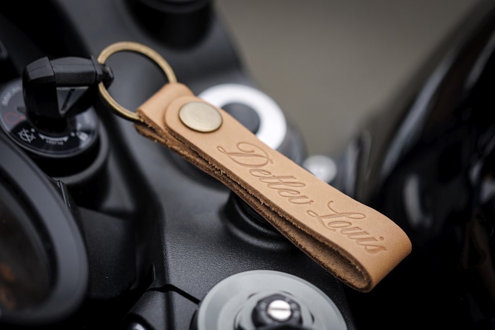 a leather keychain with a name tag on it