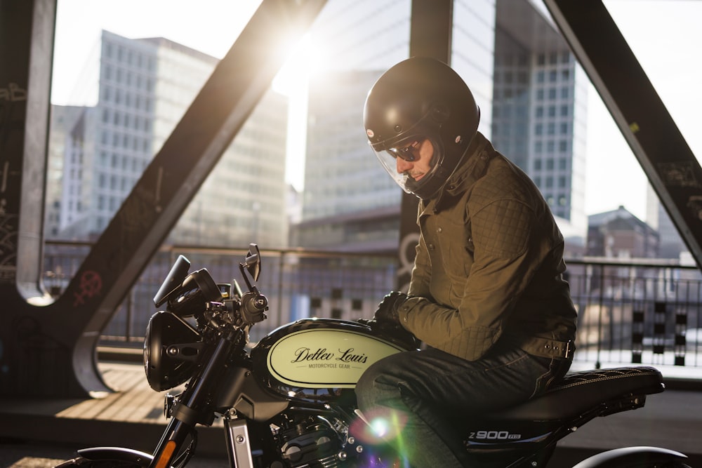 a man sitting on a motorcycle in the sun