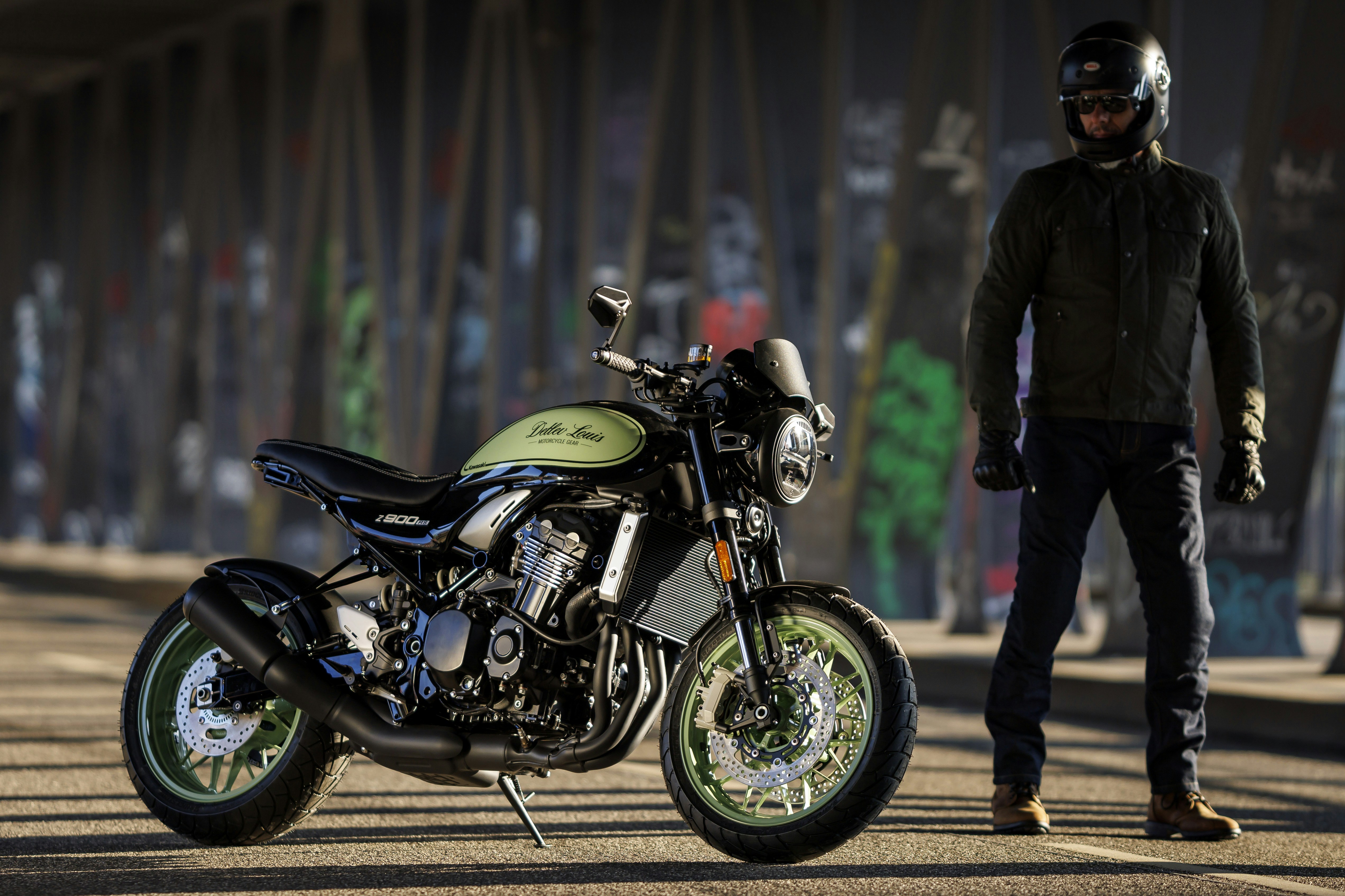 a man standing next to a parked motorcycle