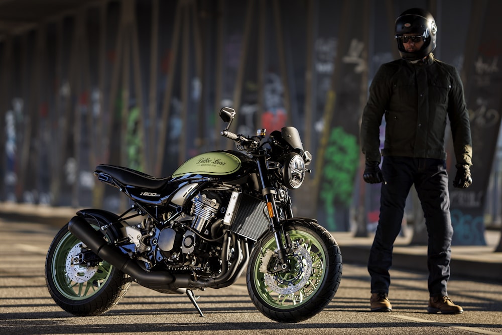 a man standing next to a parked motorcycle