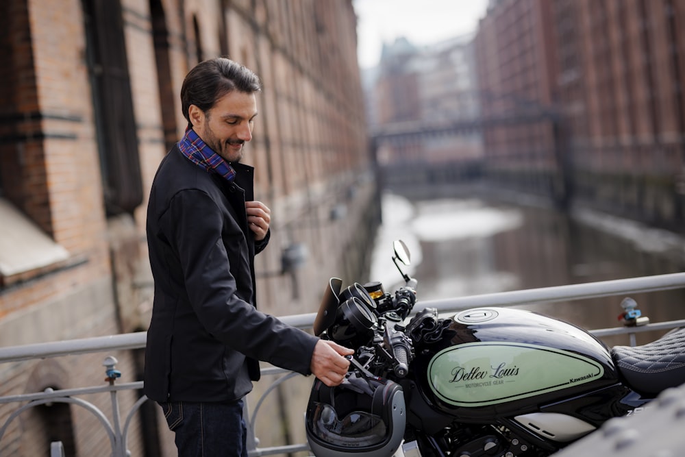 a man standing next to a parked motorcycle