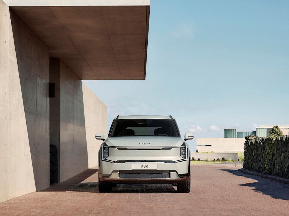 a white suv parked in front of a building