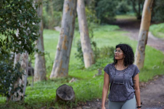 A person enjoying a calm walk outdoors in nature, smiling and relaxed.
