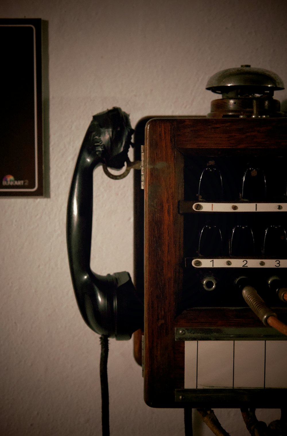 an old fashioned telephone with wine glasses on it