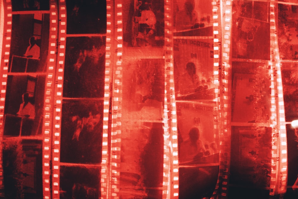 a man standing in front of a wall of film