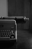 Dark, moody photo of a vintage typewriter with a half-typed edgy sentence on the paper.