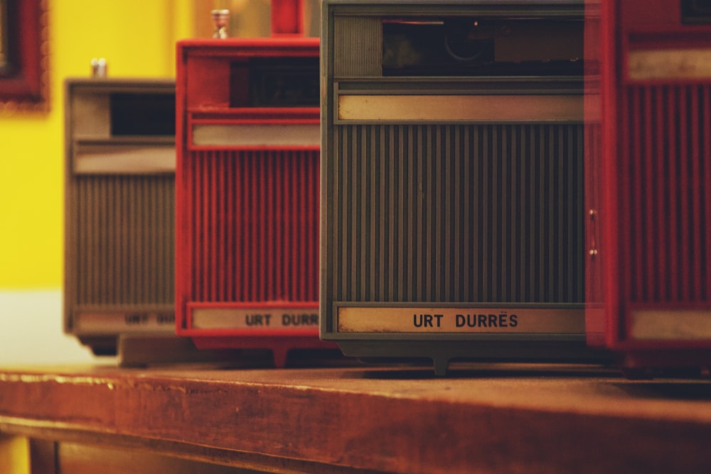 a row of old fashioned radio's sitting on a table