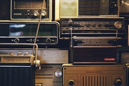 a bunch of old radio's are stacked on top of each other
