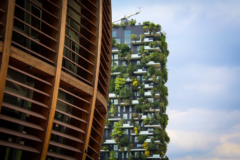 a very tall building with a bunch of plants growing on it