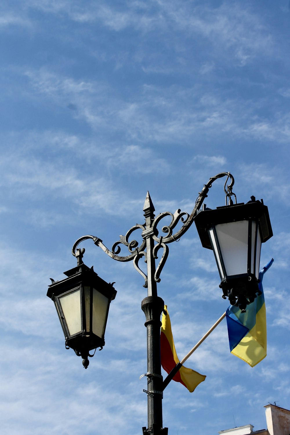 um poste de iluminação pública com uma bandeira pendurada ao seu lado