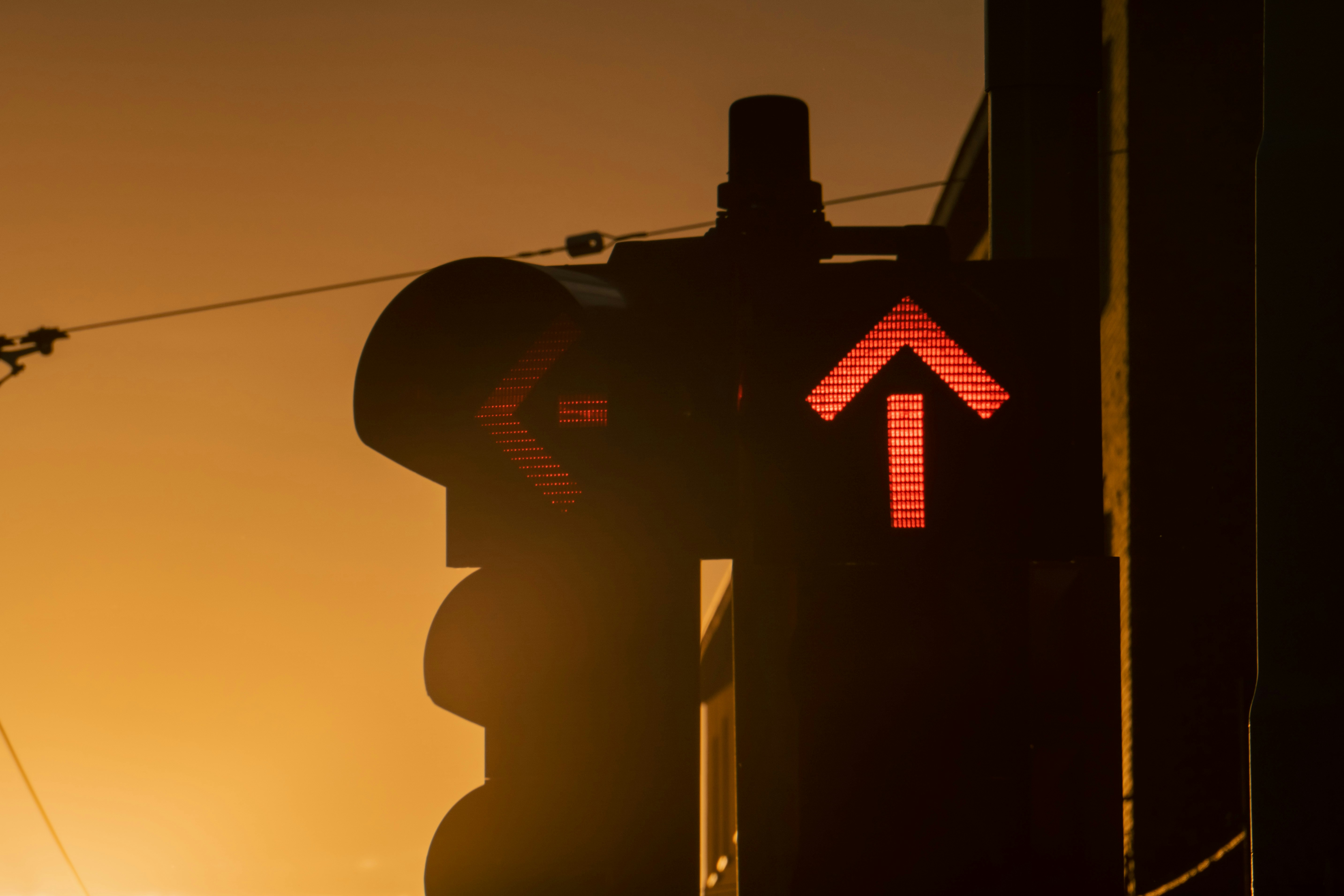 a traffic light with a red arrow on it