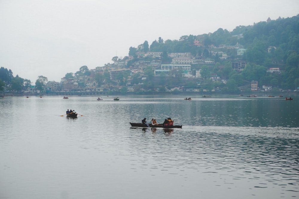 a group of people in canoes paddling on a lake