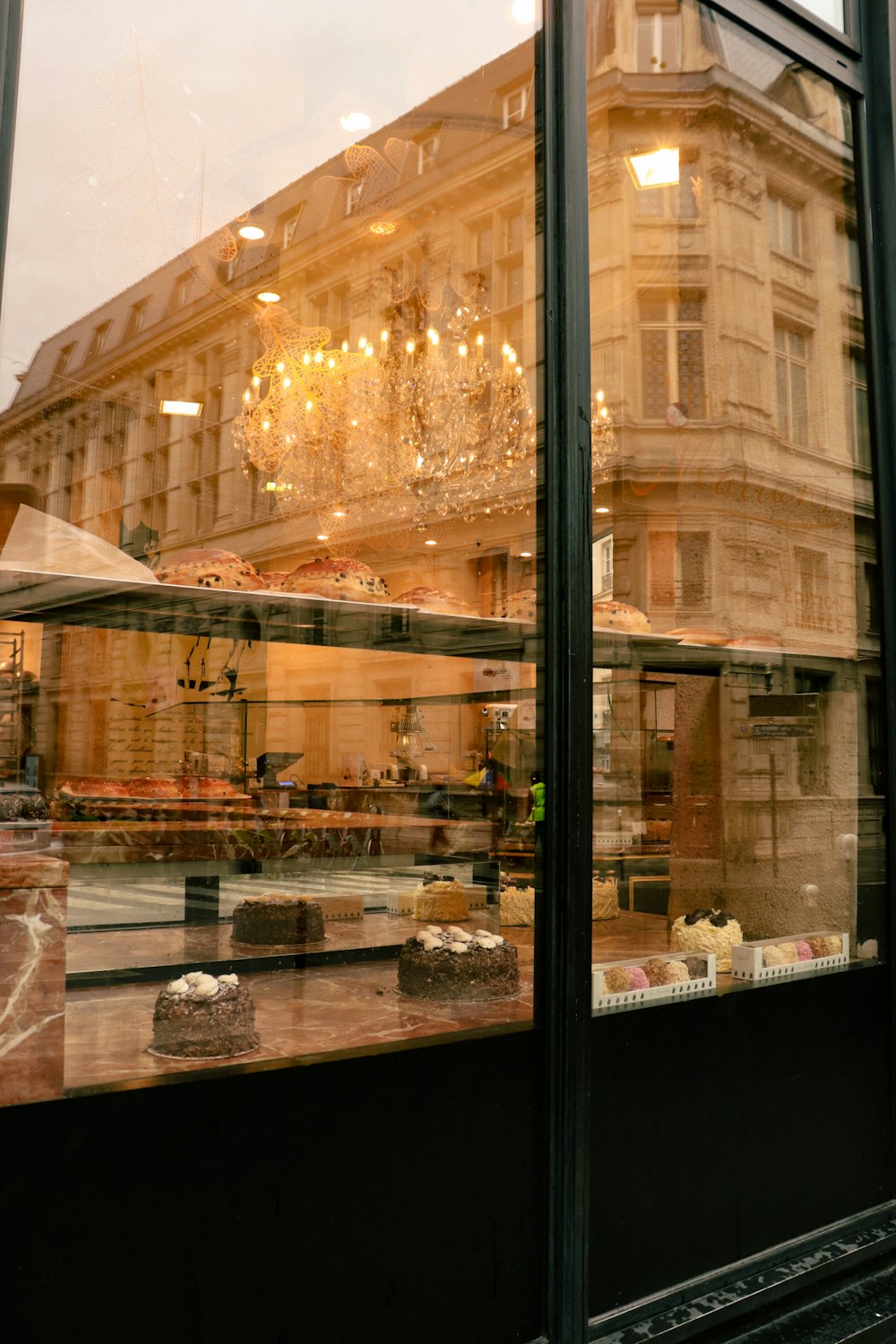 a store front window with a chandelier in the window