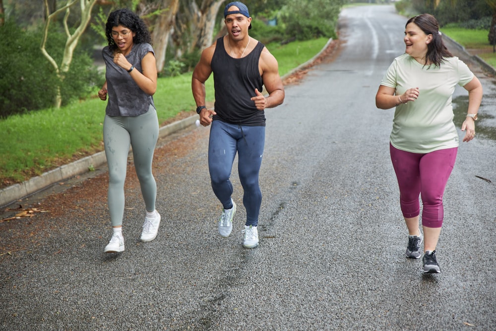 a man and two women running down a road