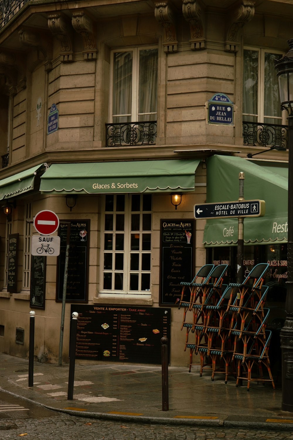 a building with a green awning next to a street