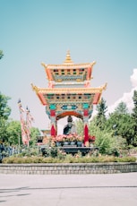 a pagoda with a statue in front of it