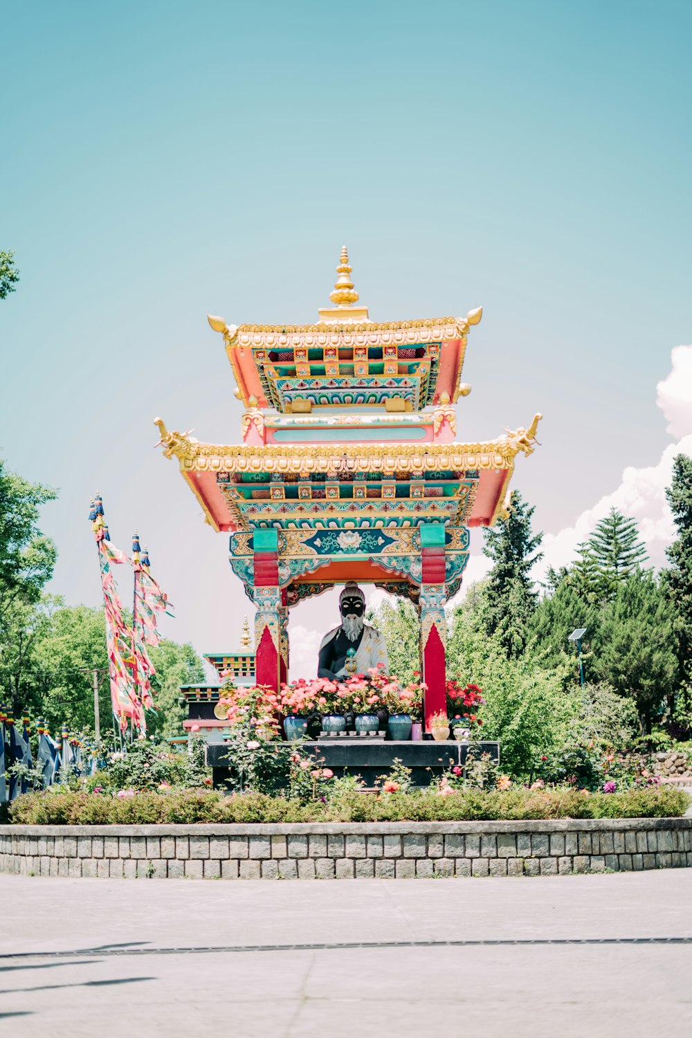 a pagoda with a statue in front of it