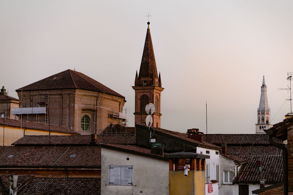 Un campanario de iglesia se eleva sobre una hilera de edificios