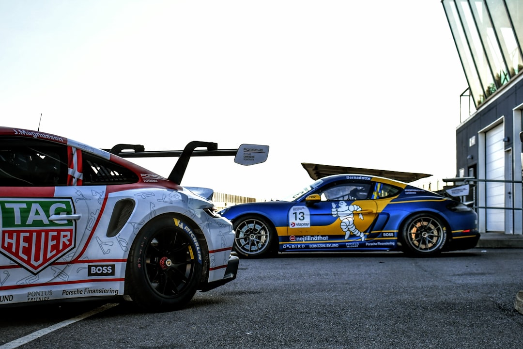 two race cars parked next to each other in a parking lot,