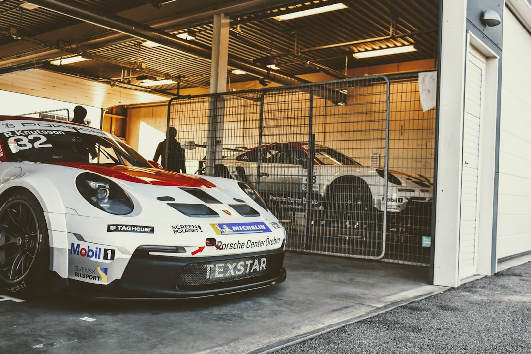 a white and red race car parked in a garage,