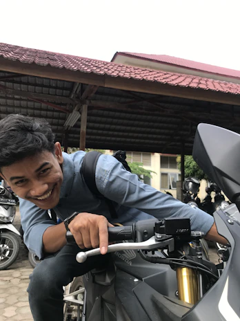 A smiling local handing over scooter keys to a guest ready for a long-term ride.